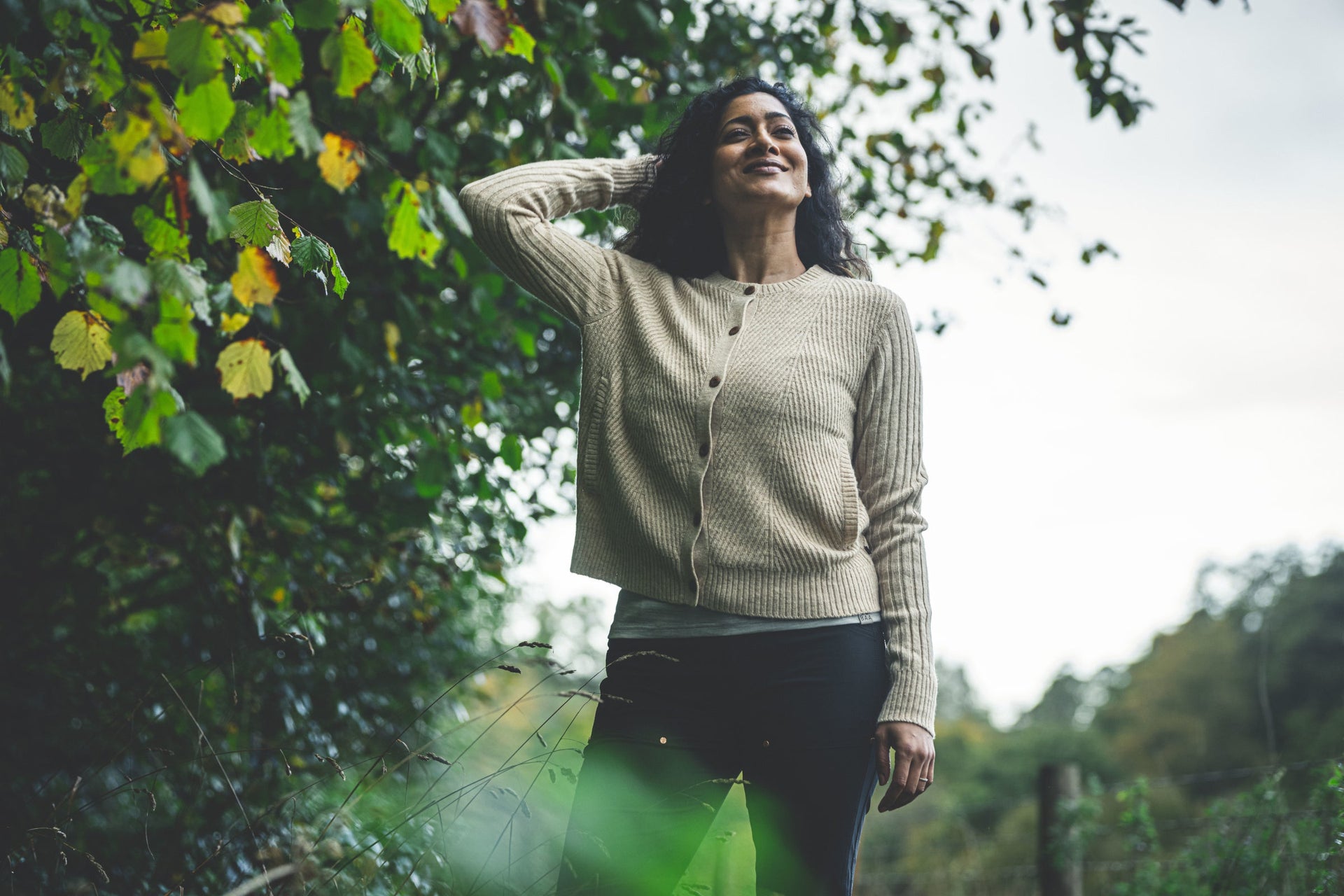 Woman outdoors wearing a beige cardigan