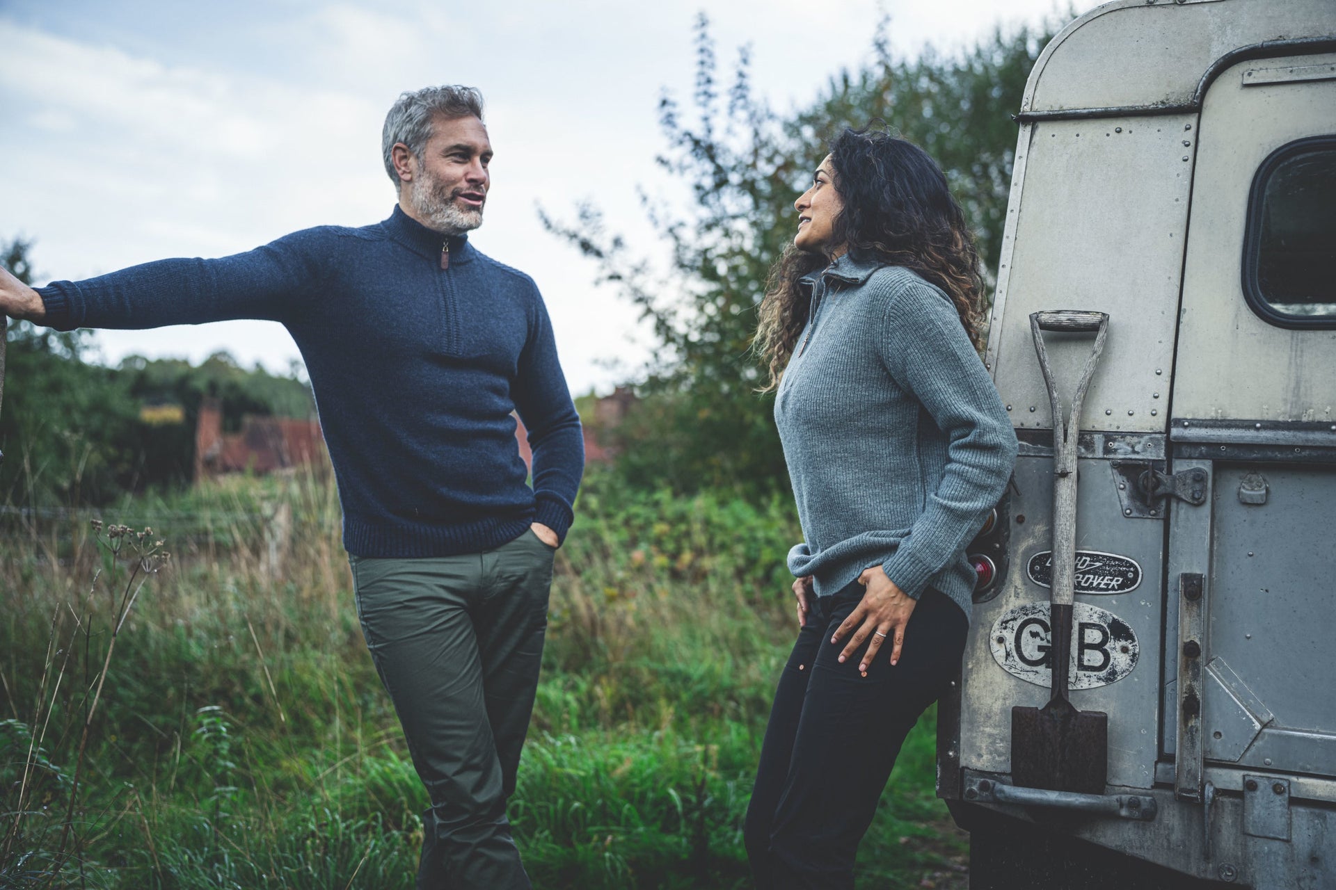 Man and woman outdoors in zip-neck sweaters