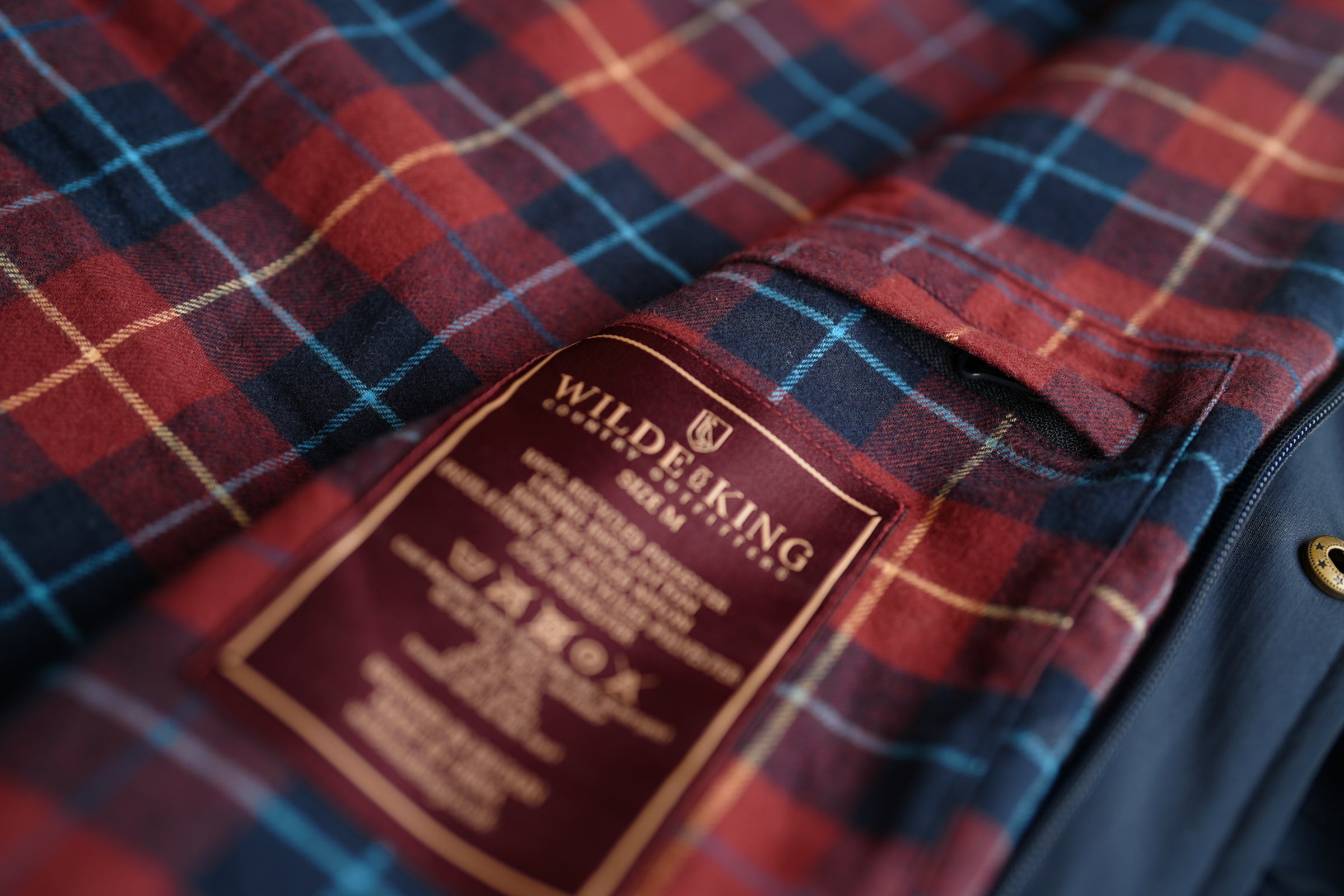 Red and blue plaid fabric with a Wilde & King logo label