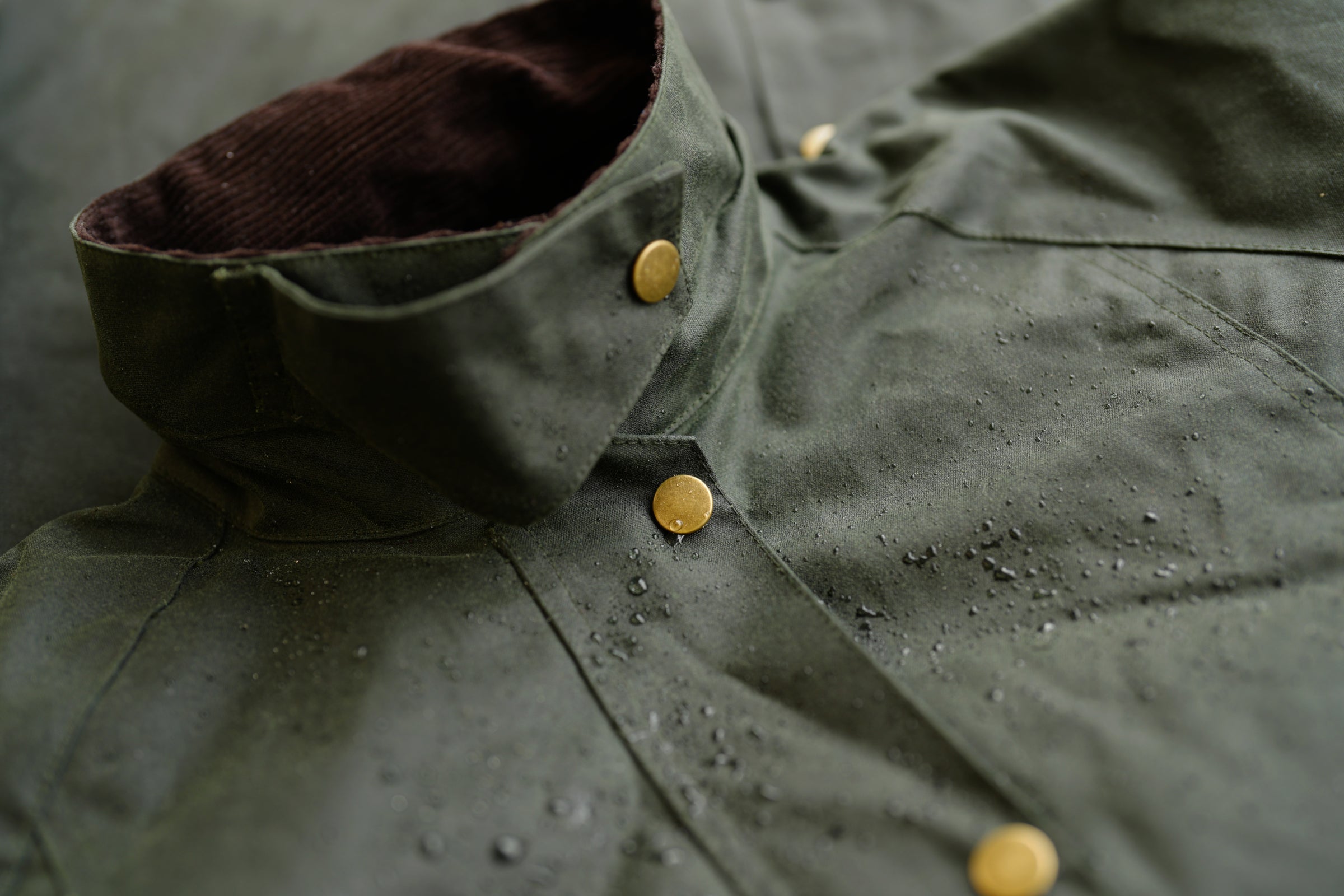 Wilde & King waxed jacket with water droplets and brass buttons